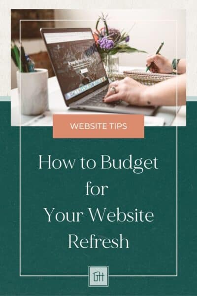 A person writes notes beside a laptop with a budgeting article on website refresh tips. The setting includes flowers and a mug.